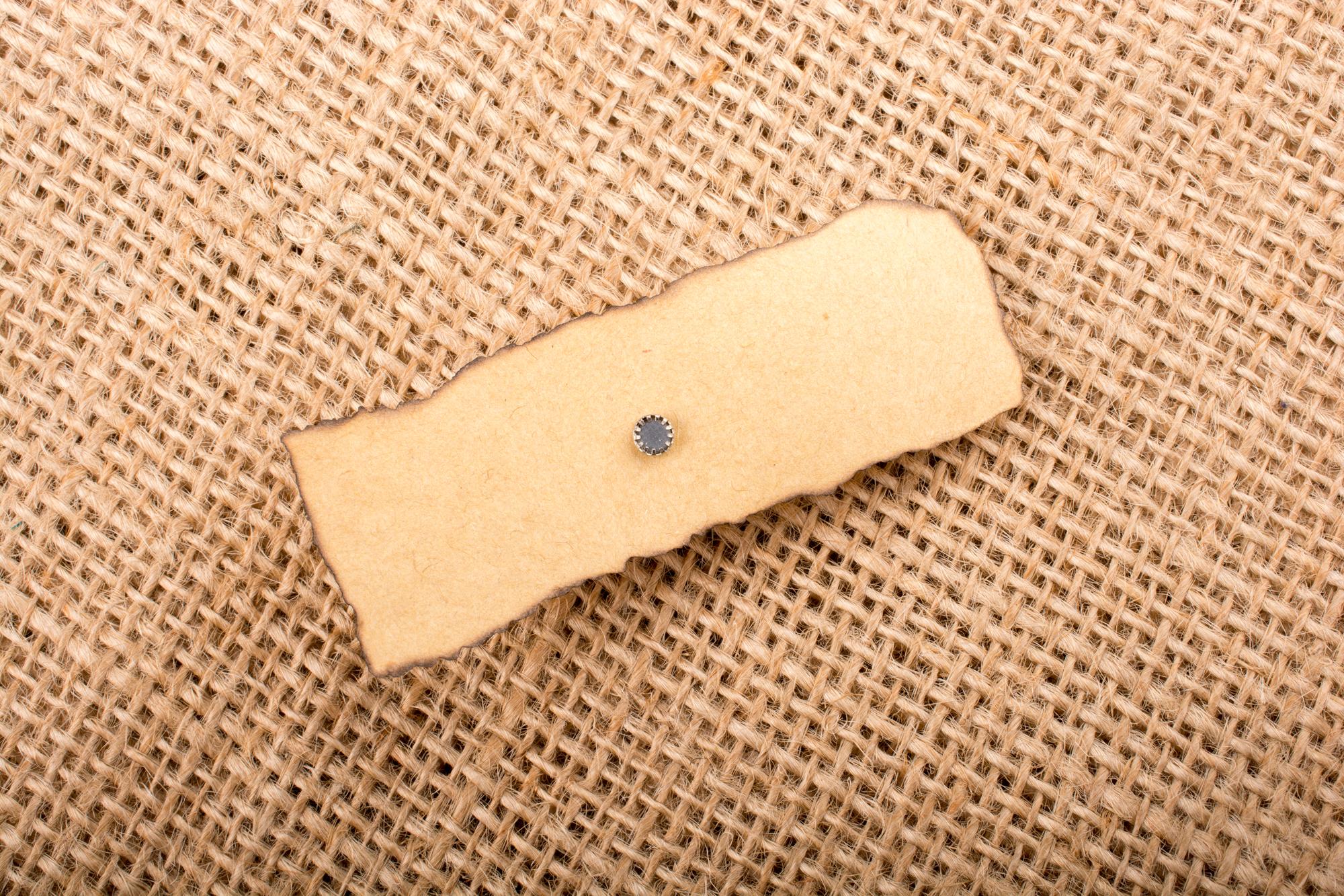 three embroidered patches on kraft paper
